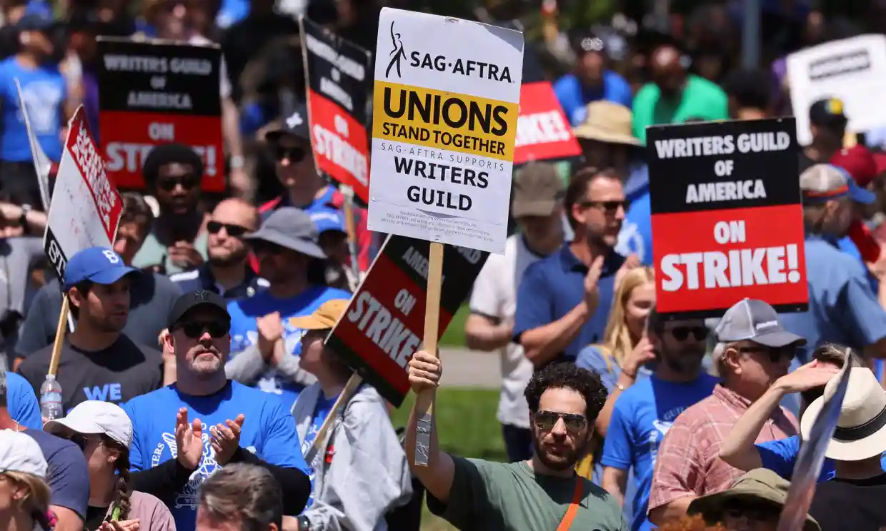 People at a demonstration by the Writers Guild of America on 21 June 2023. Photograph: Mike Blake/Reuters