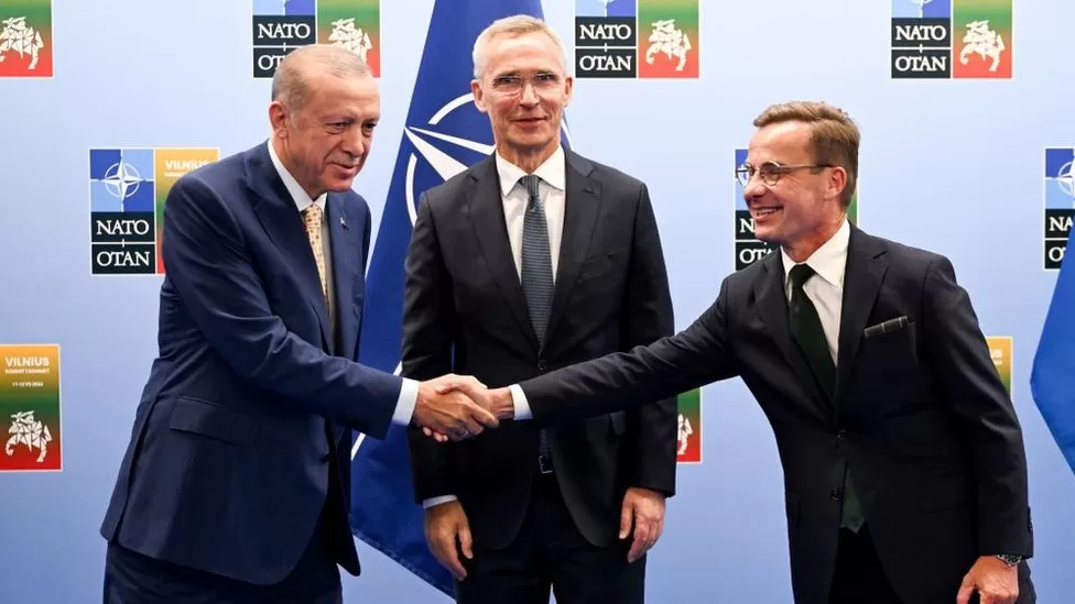 EPA  / Turkish President Recep Tayyip Erdogan and Swedish Prime Minister Ulf Kristersson shake hands with Nato chief Jens Stoltenberg looking on