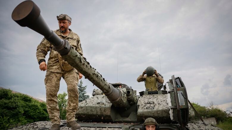 Ukrainian soldiers on a Swedish CV90 infantry fighting vehicle near Bakhmut, Donetsk region. Ukrainian platoons continue to chip away at Russia’s northern and southern flanks, but the advance has been slow. (Roman Chop/The Associated Press)