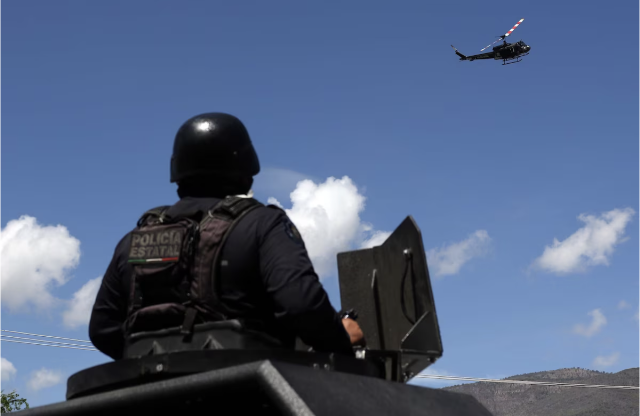  A police helicopter flies above the protest Monday. (Jose Luis De La Cruz/EPA-EFE/Shutterstock)