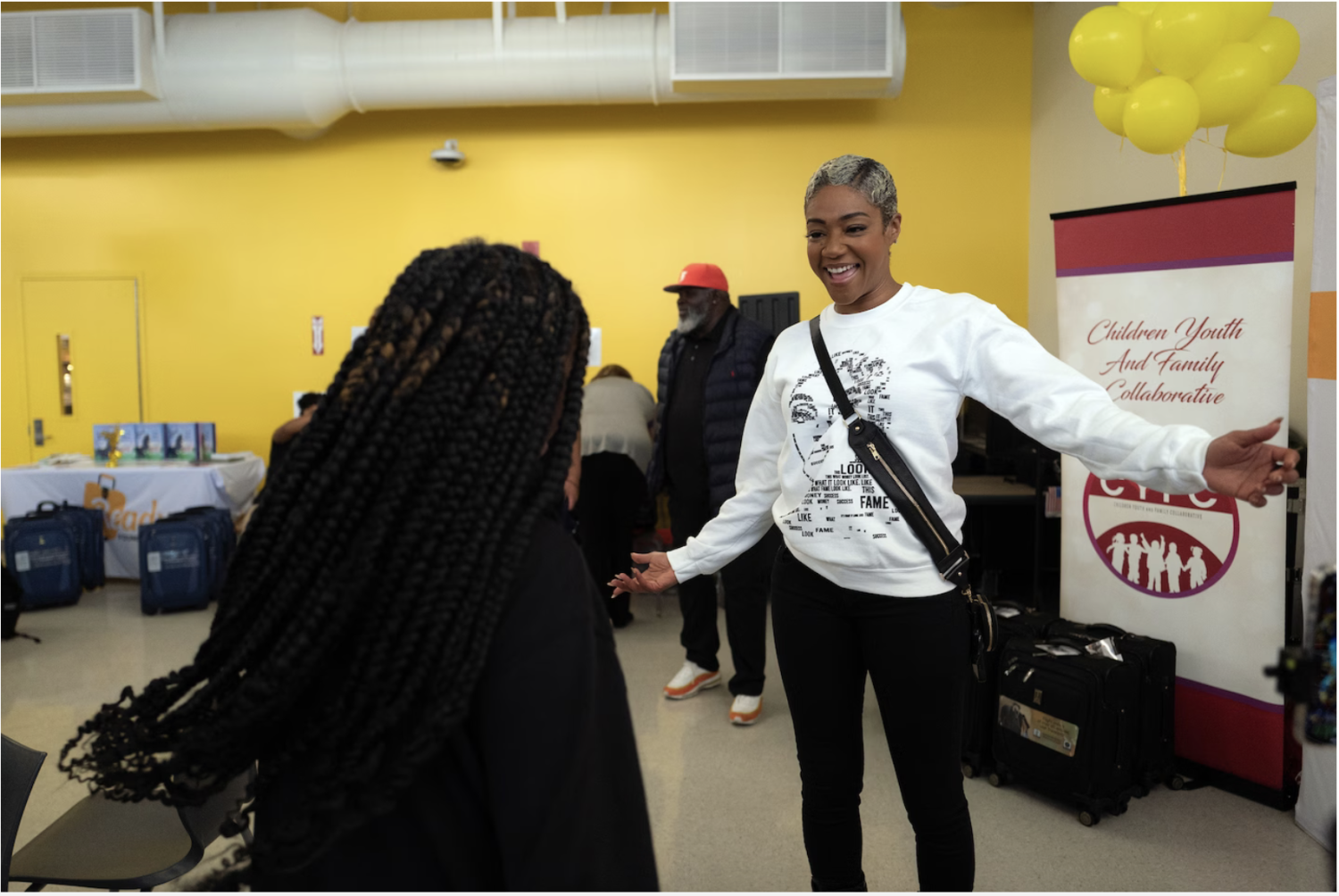 Haddish greets a student of Crenshaw High School in Los Angeles at an event sponsored by her She Ready Foundation and Children Youth and Family Collaborative. (Zaydee Sanchez for The Washington Post)
