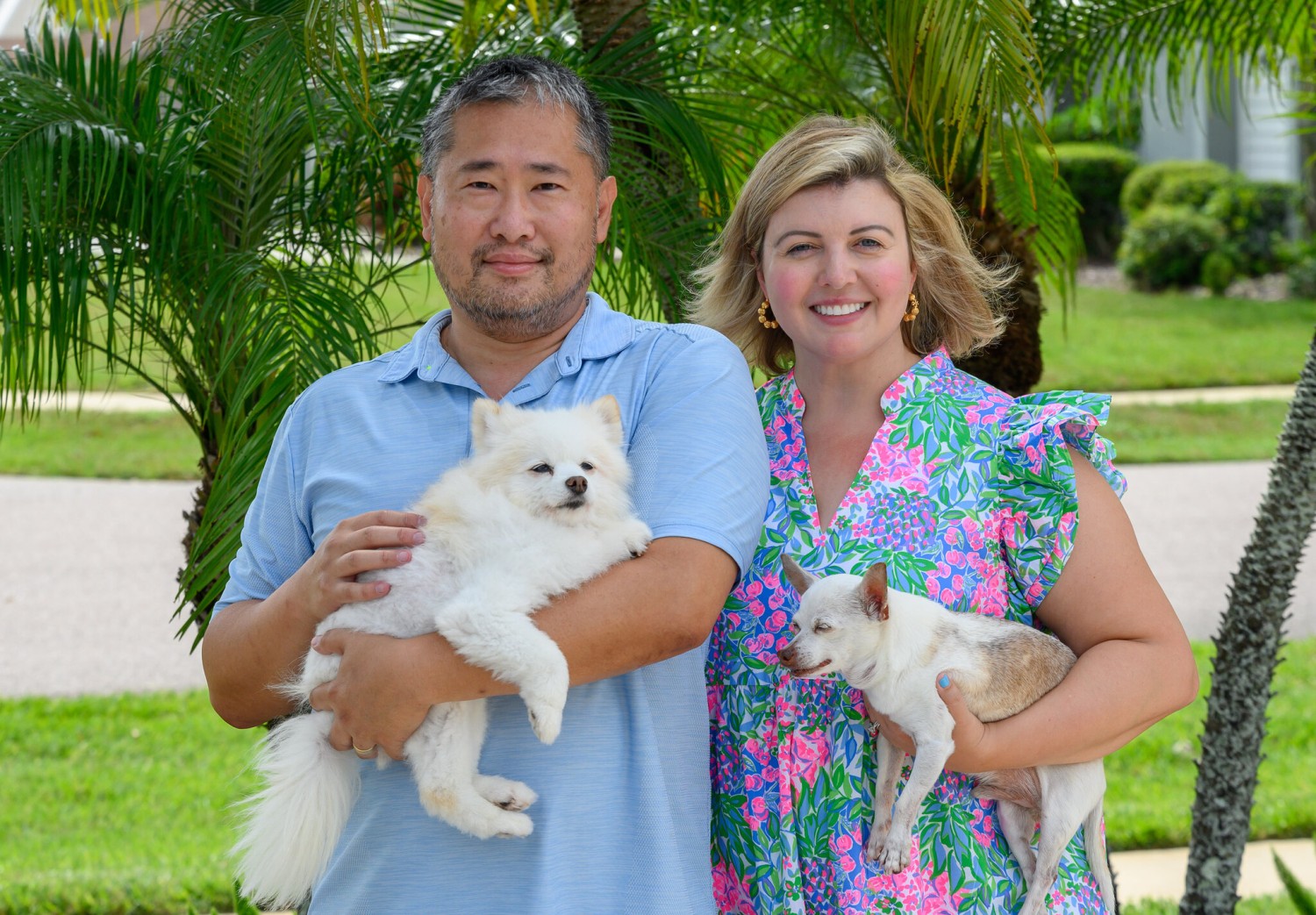 Linus and Anne Chow with their dogs, Bella, left, and Vito, near their new place in Florida. The couple wanted “a newer home, one that had been updated,” Ms. Chow said. Todd Anderson for The New York Times