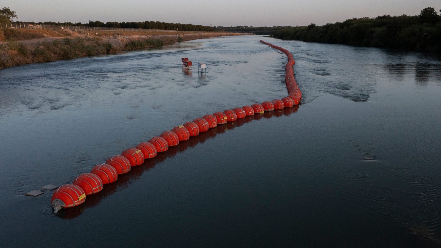 Omar Ornelas/El Paso Times/USA Today Network | Buoys placed by the state of Texas float on the Rio Grande international boundary between Mexico and the US in Eagle Pass, Texas, on July 21, 2023.