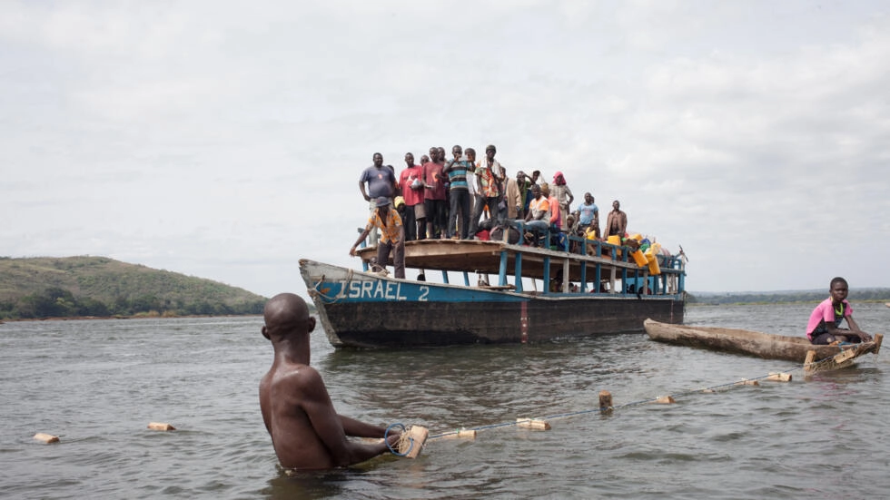 In this file photo, a boat passes in front of the Mobaye refugee fishermen in Longo island, along the Oubangui River, in the Damara district of Central African Republic on March 1, 2018. © Florent Vergnes, AFP