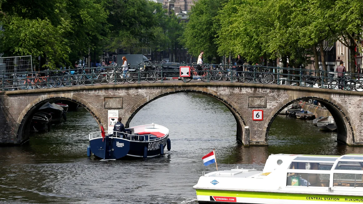 Tourist boats cruise on a canal in Amsterdam. Francois Lenoir/Reuters