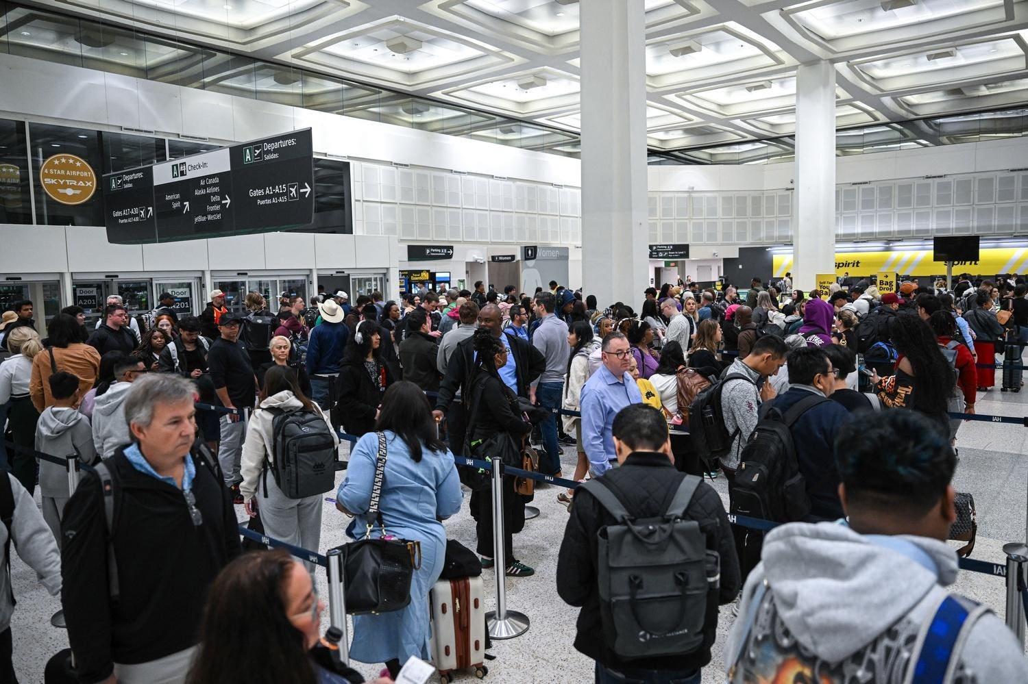 Travelers wait in line at a TSA security checkpoint at George Bush Intercontinental Airport in Houston, Texas. PHOTO BY RONALDO SCHEMIDT / AFP VIA GETTY IMAGES