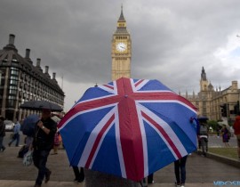 A pedestrian shelters from the rain beneath an umbrella in London. The U.K. referendum prompted Prime Minister David Cameron, who supported staying in the EU, to step down.