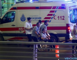 Paramedics help a man in a wheelchair at Turkey's largest airport, Istanbul Ataturk, Turkey, following a blast June 28, 2016.