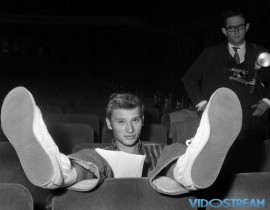 The young Hallyday, born Jean-Philippe Smet on June 15, 1943 in Paris, enjoys a break from rehearsing at the Olympia in October 1962.