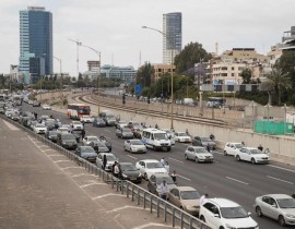 People stop and stand in silence on a highway in the Israeli city of Tel Aviv on April 24, 2017, as sirens wailed across Israel for two minutes marking the annual day of remembrance for the six million Jewish victims of the Nazi genocide. Israel bega