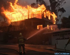 A home in Ventura goes up in flames as the Thomas Fire descends down from the hills.