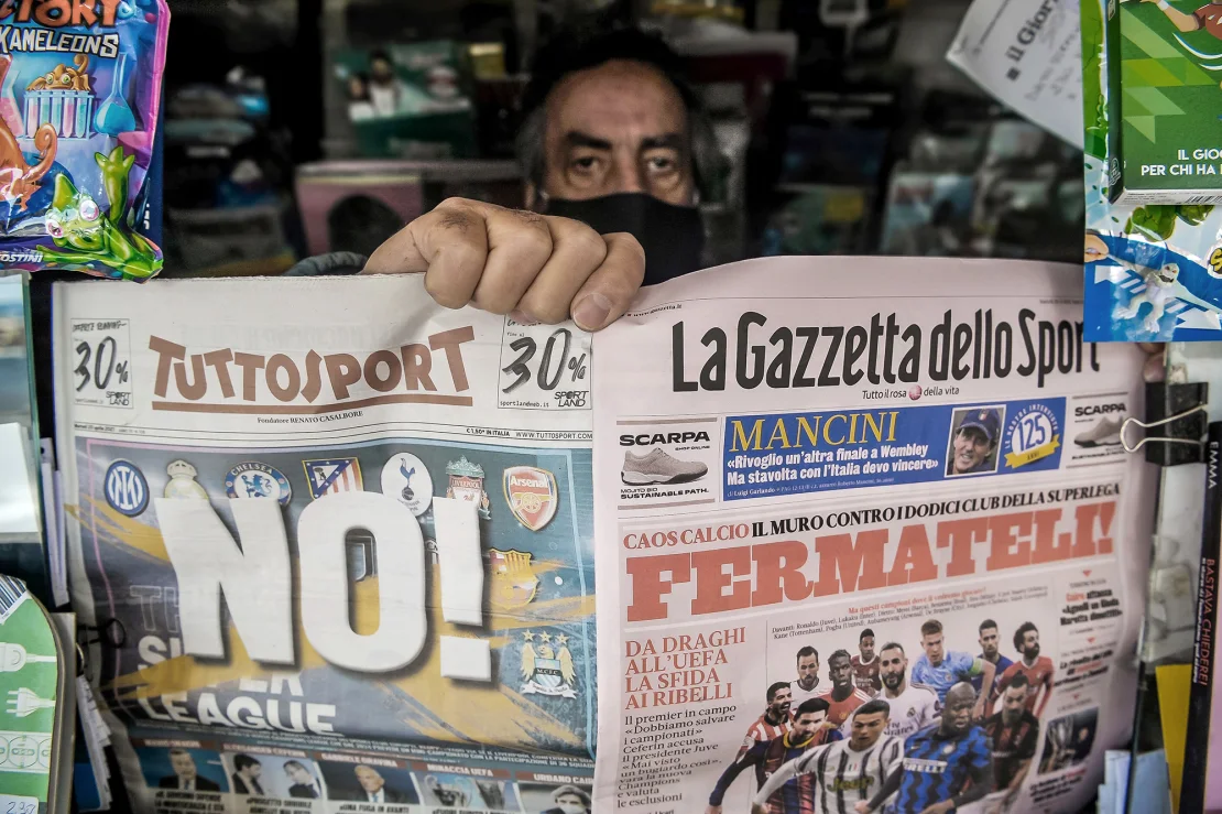 Laura Lezza/Getty Images. A newsagent shows two pages of the main Italian sports newspapers with a headline regarding the Super League reading 'No!' and 'Fermateli!' ('Stop them!) on April 20, 2021, in Livorno, Italy.